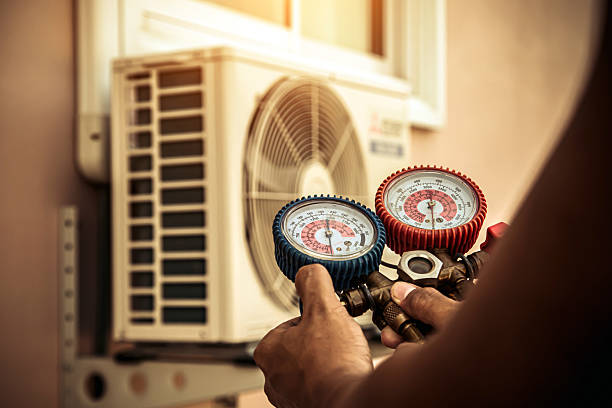 Professional Air Conditioning Service technician working in Rogers, AR